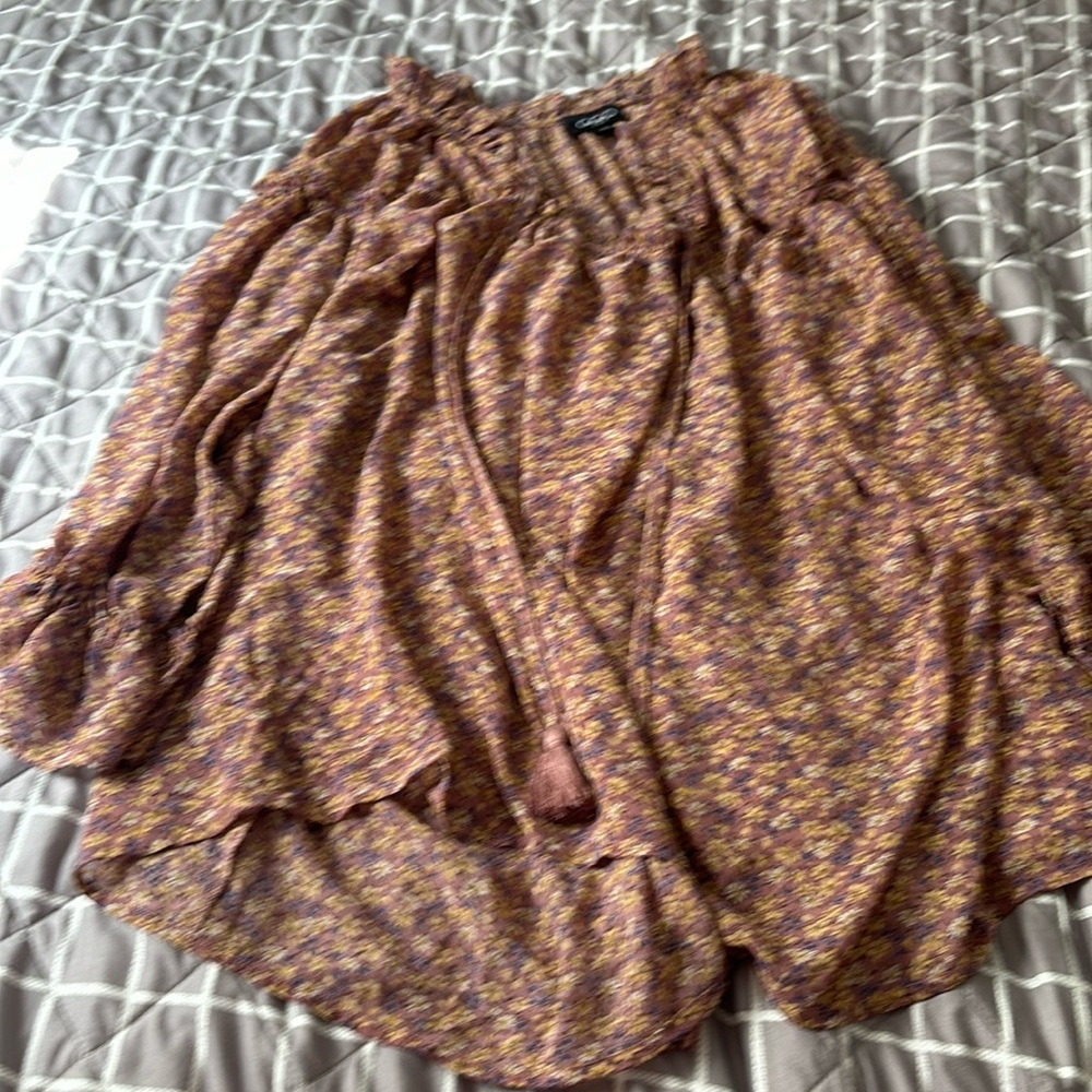 Silky blouse with flowers. It’s an oversized small that flows beautiful.